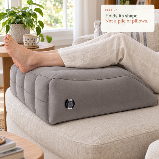 Feet up on the inflatable leg wedge on a linen sofa. Holds its shape, not a pile of pillows.