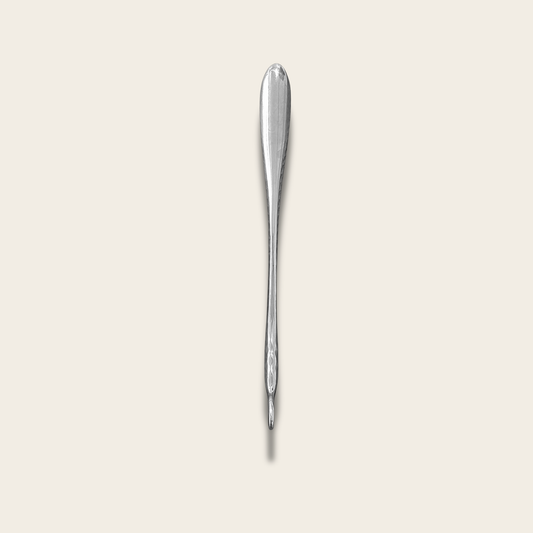 The Steel Shoe Horn in polished stainless steel, full length, on a cream background