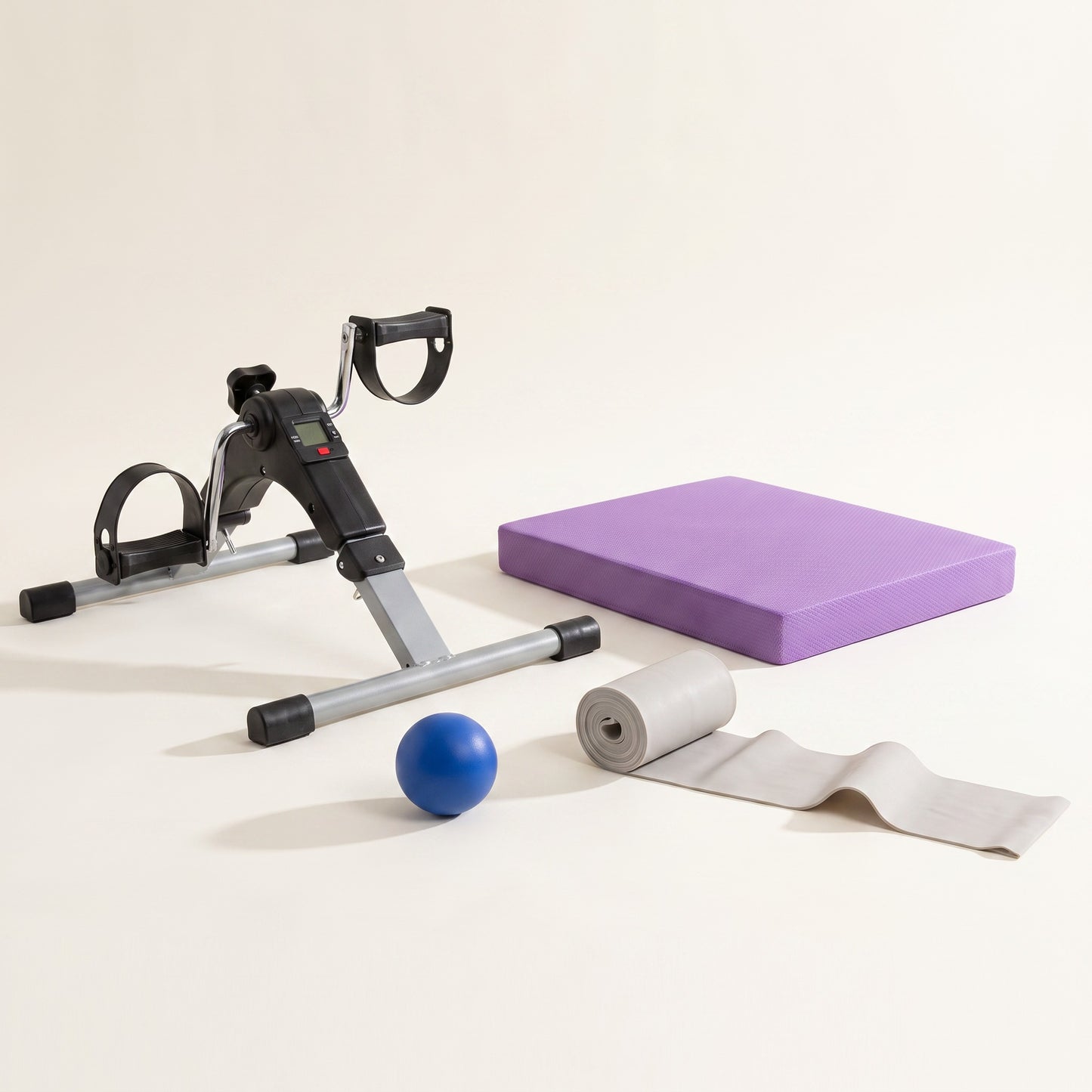 The Complete Basics Kit seen from floor level, showing the height of the pedal exerciser and the thickness of the balance pad.
