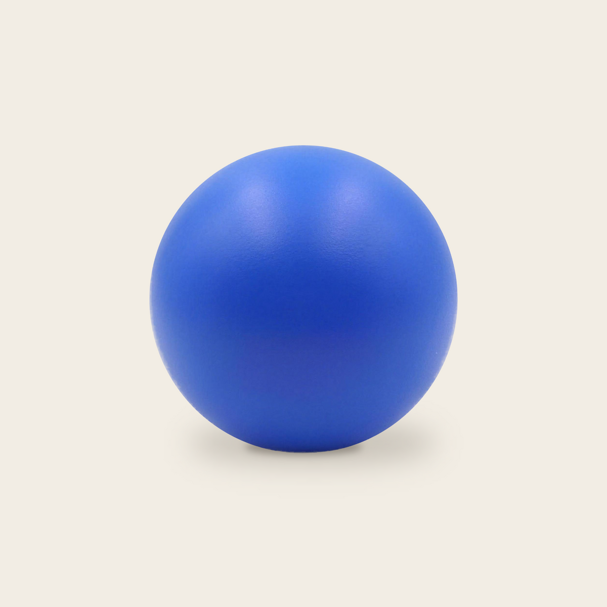 Soft grip strength ball in blue on a cream background