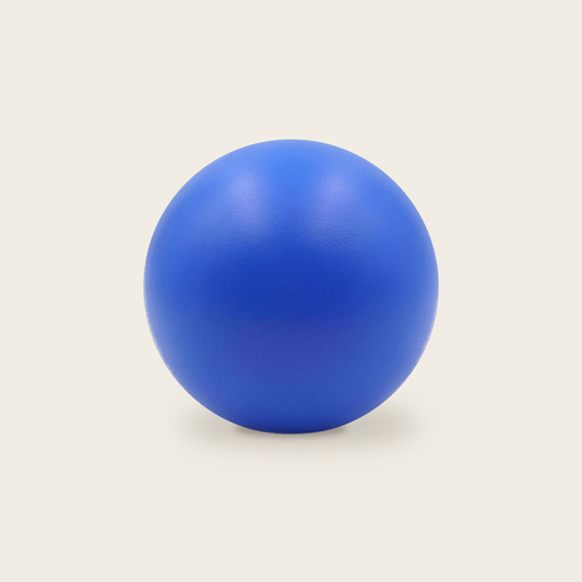 Soft grip strength ball in blue on a cream background