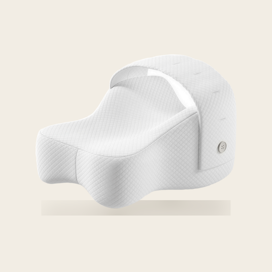 Orthopaedic knee pillow in white with adjustable strap on a cream background
