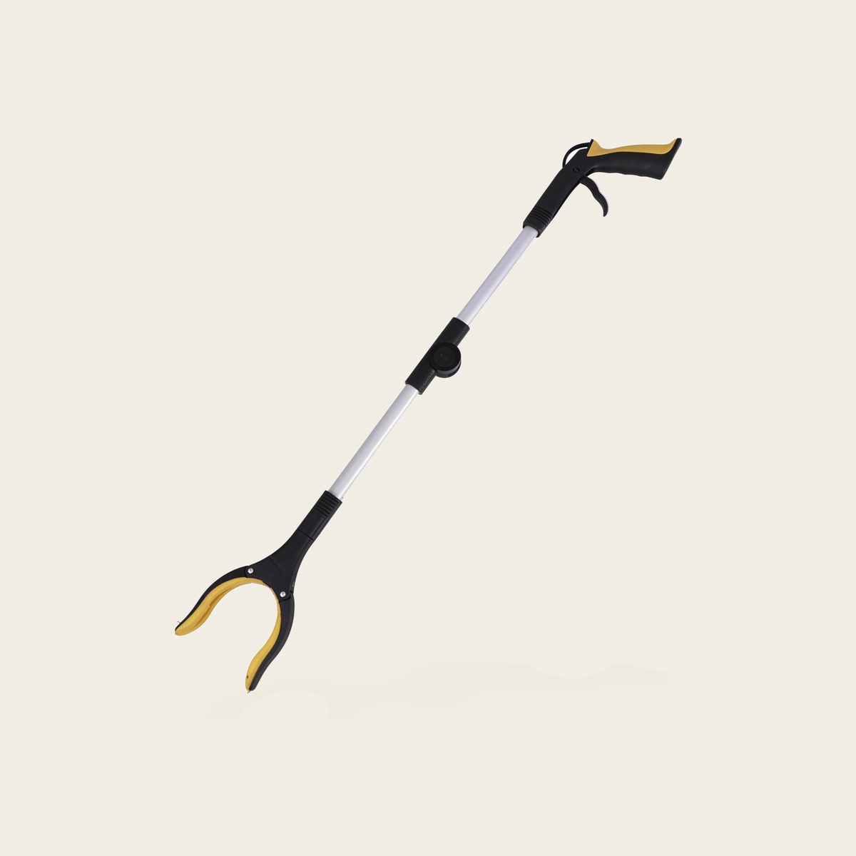 Foldable long reach grabber on a cream background