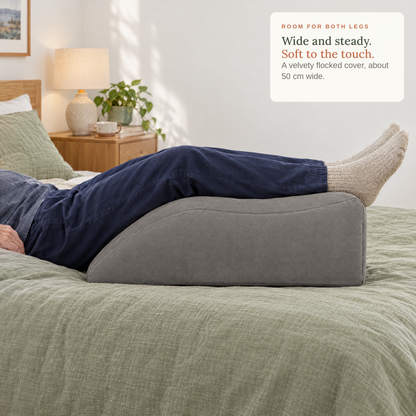 Legs resting on the wedge on a bed. Wide and steady, soft to the touch.
