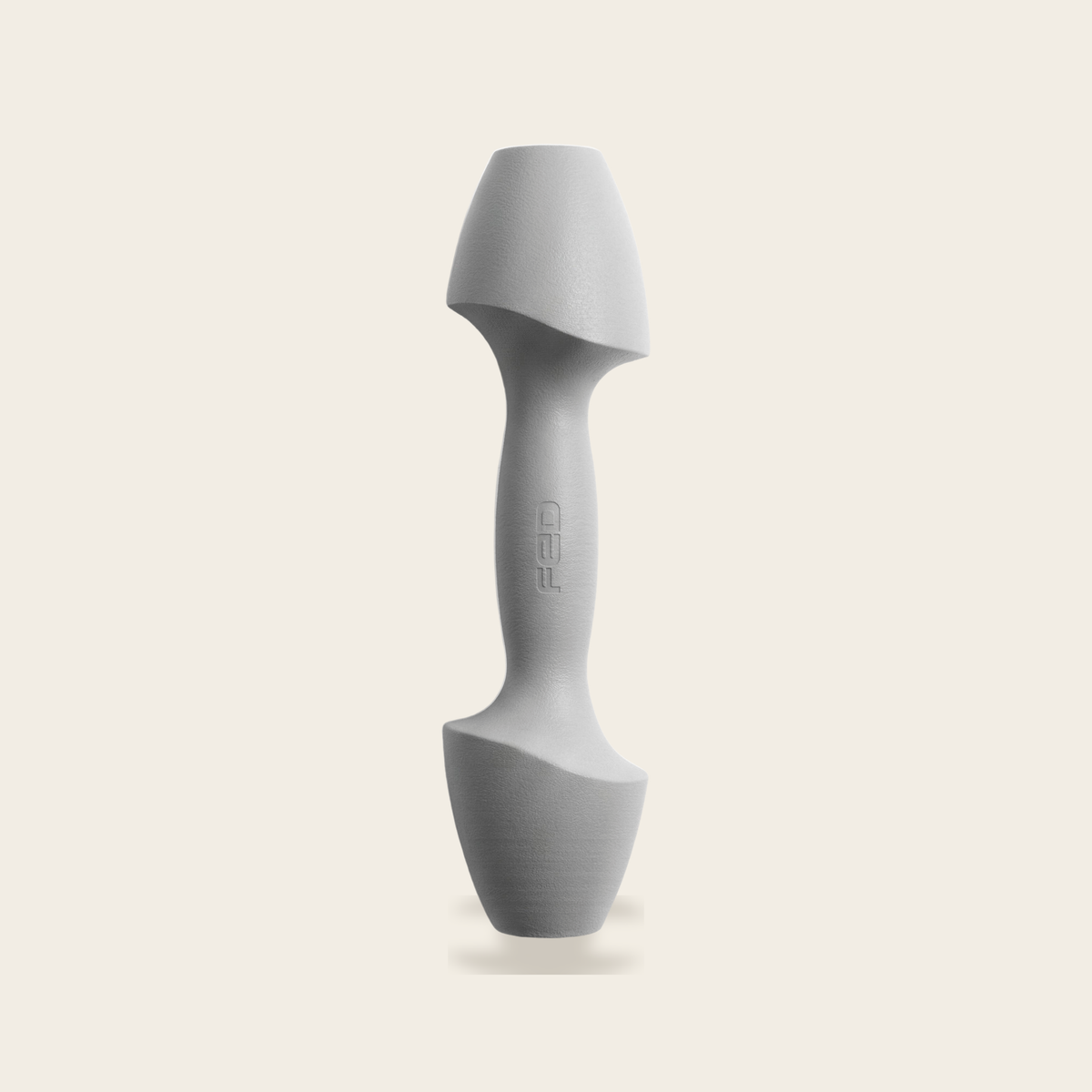 The Sculpt Dumbbell in grey on a cream background