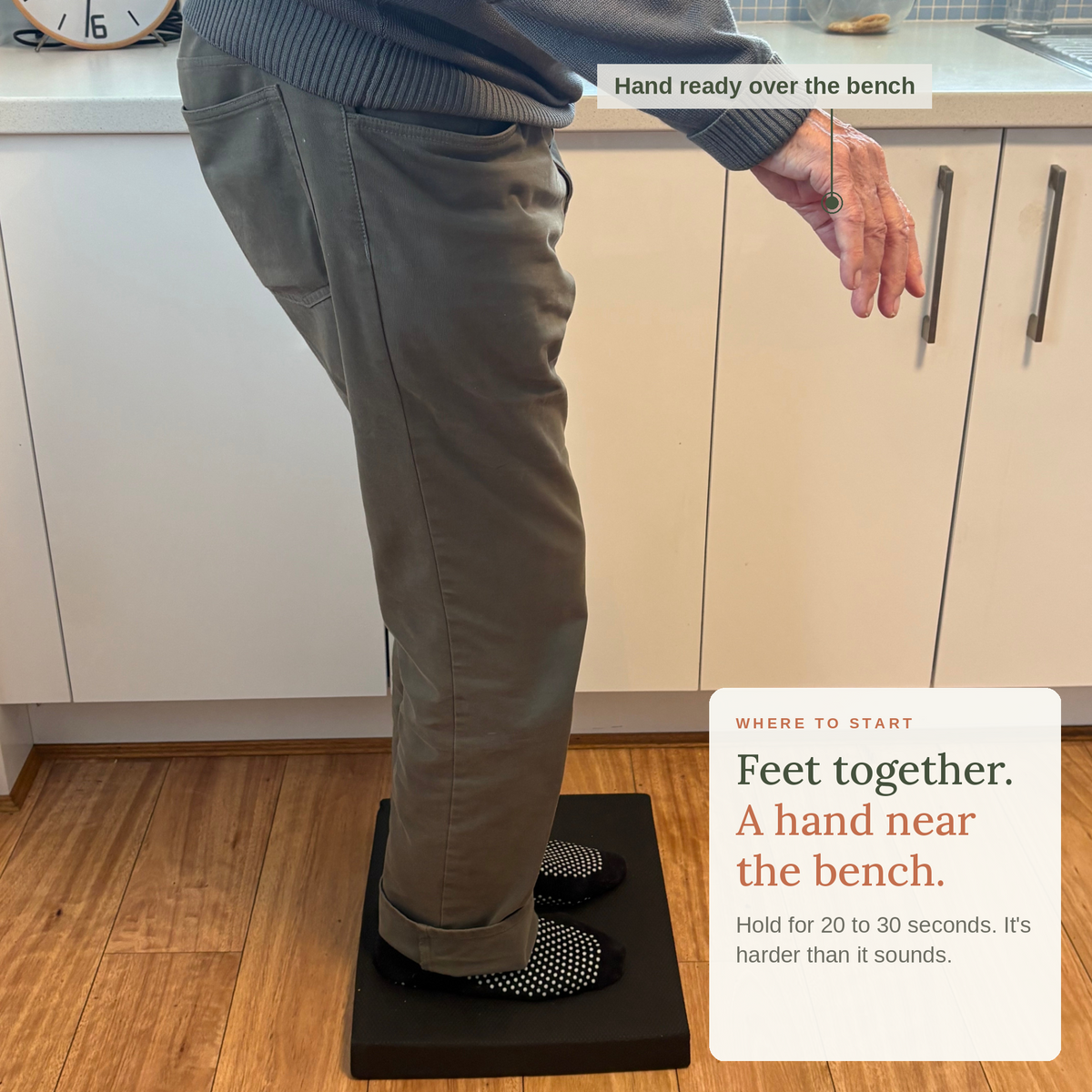 Man standing feet together on the balance pad with a hand ready over the kitchen bench: where to start