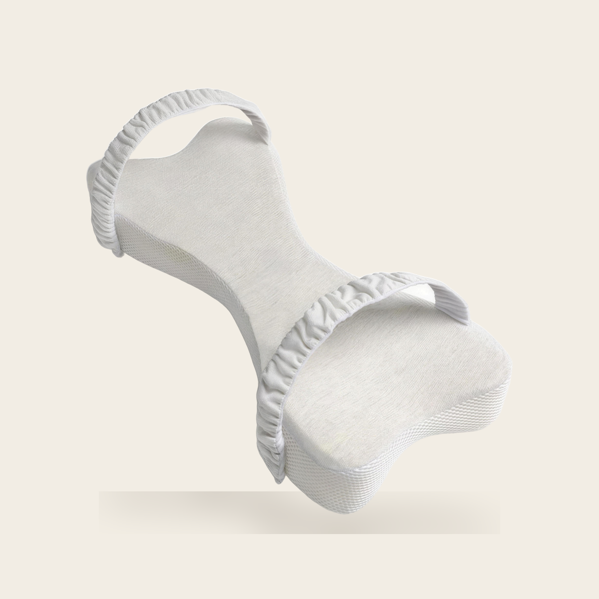 Bone shaped long knee pillow in light grey with two ruched straps on a cream background