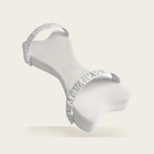 Bone shaped long knee pillow in light grey with two ruched straps on a cream background