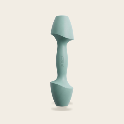 The Sculpt Dumbbell in azure on a cream background
