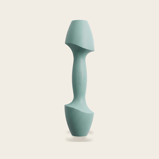 The Sculpt Dumbbell in azure on a cream background
