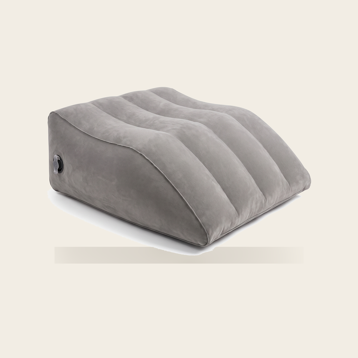 Inflatable leg wedge in grey on a cream background