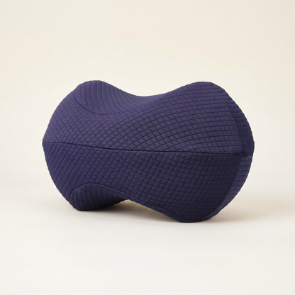 Navy Bean Knee Pillow with a quilted cover on a cream background