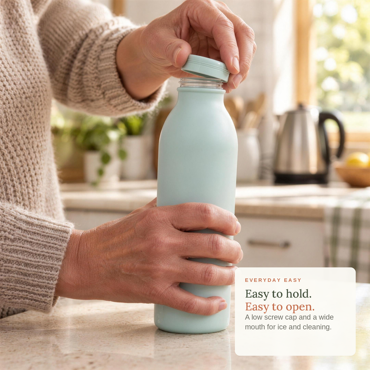 Hands unscrewing the low cap of the bottle in a kitchen. Easy to hold, easy to open.