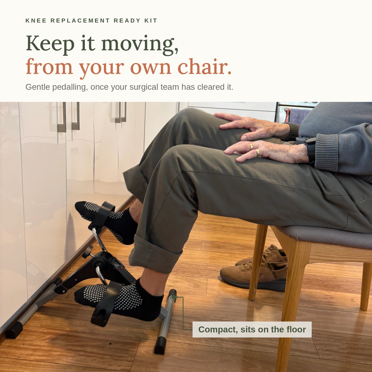 Keep it moving, from your own chair. An older person seated on a kitchen chair using the compact mini pedal exerciser on the floor. Gentle pedalling, once your surgical team has cleared it.