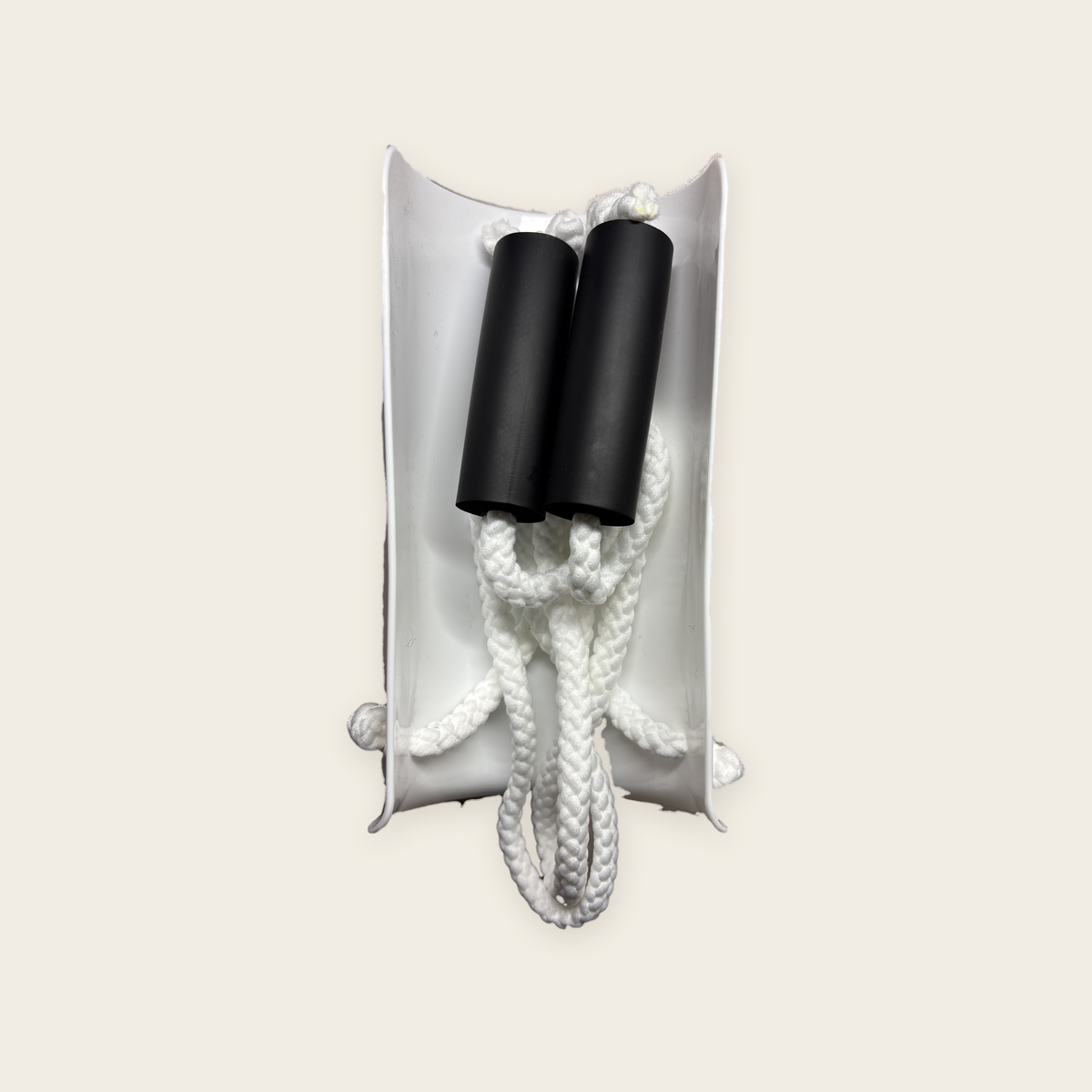 The Sock Aid packed away, with both foam handles and cords tucked inside the shell