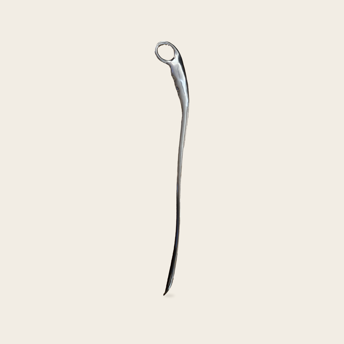 The Steel Shoe Horn in polished stainless steel on a cream background