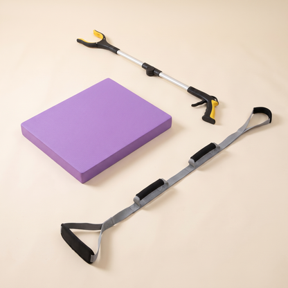 Balance & Independence Kit on a cream background: purple balance pad, foldable long reach grabber and triple grip leg lifter strap.
