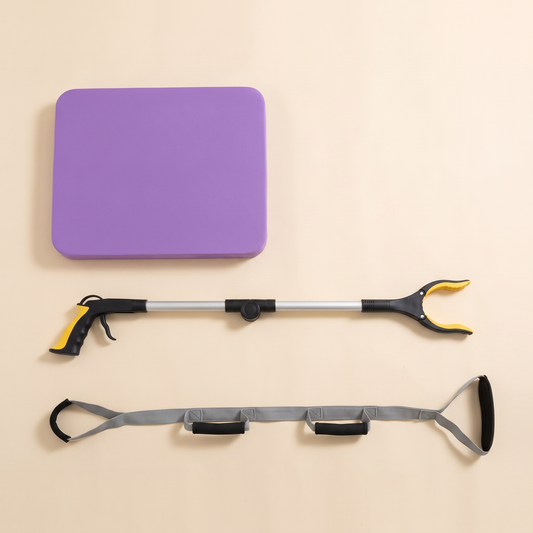 Overhead view of the kit: purple balance pad, extended long reach grabber, and the leg lifter strap laid flat showing its padded grips and foot stirrup.