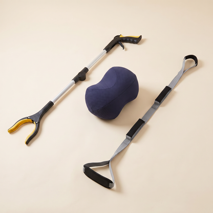Everyday Independence & Comfort Kit on a cream background: foldable long reach grabber, navy bean knee pillow and triple grip leg lifter strap.