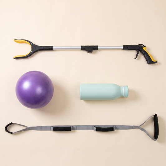 Overhead view of the Hip Replacement Ready Kit contents: extended long reach grabber, purple exercise ball, mint green water bottle and the leg lifter strap laid flat.