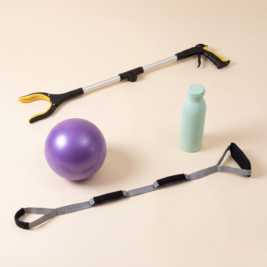 Three-quarter view of the Hip Replacement Ready Kit with the grabber, exercise ball, water bottle and leg lifter strap.