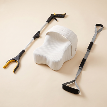 Everyday Independence & Comfort Kit on a cream background: foldable long reach grabber, orthopaedic knee pillow and triple grip leg lifter strap.