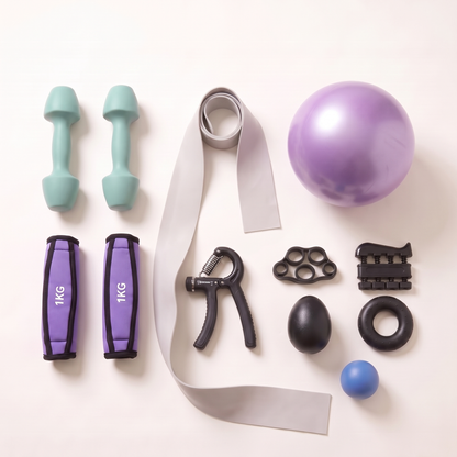 Everything in The Strength Kit laid out: mint green dumbbell pair, purple 1kg soft grip hand weights, long resistance band, five-piece grip strength set, soft grip strength ball and mini exercise ball.