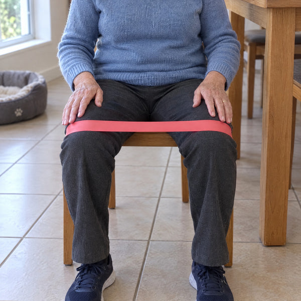 Seated with the Light loop band around both thighs, just above the knees