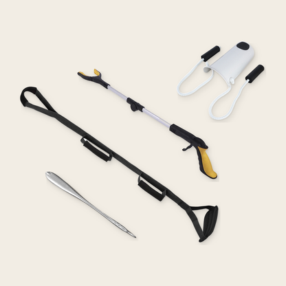 Morning Without Bending Kit on a cream background: sock aid, 52 cm steel shoe horn, orange foldable long reach grabber and black triple grip leg lifter