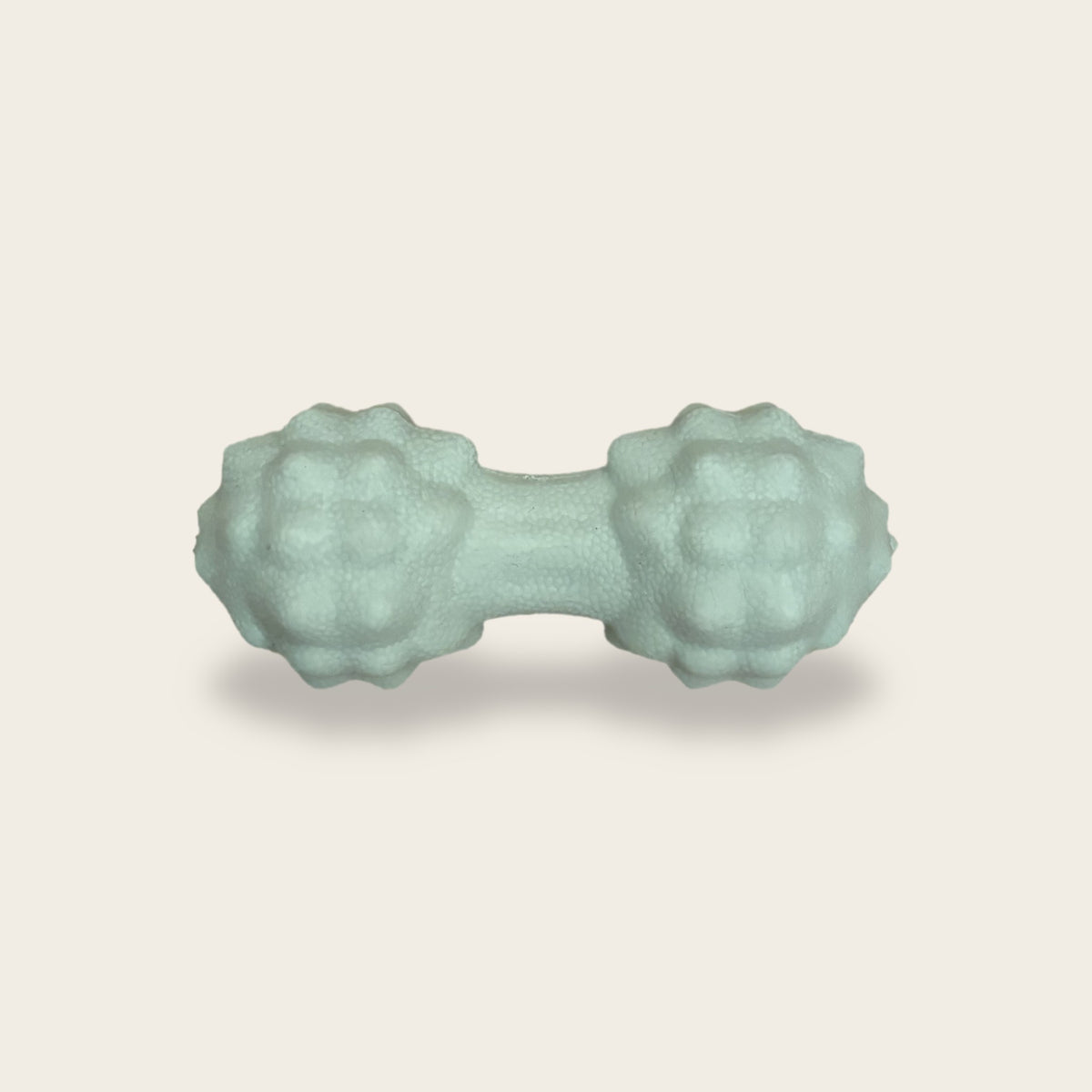 The Peanut Massage Ball in mint green, about 12 cm long with two knobbly heads