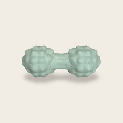 The Peanut Massage Ball in mint green, about 12 cm long with two knobbly heads