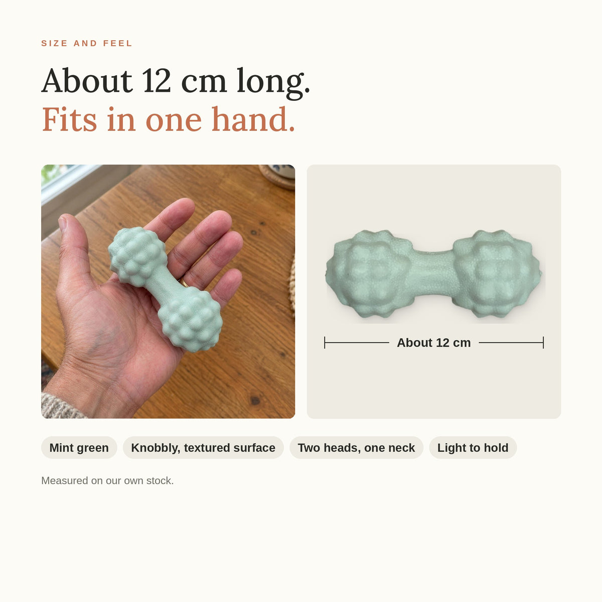 The Peanut Massage Ball held in one hand, about 12 cm long